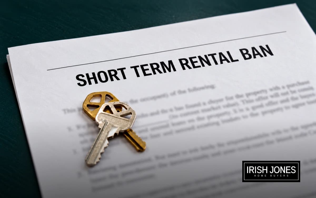 House keys resting on a document titled short term rental ban